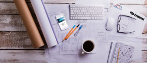 Desk with gadgets and office supplies. Computer keyboard, smart phone, housing projects and various things around the workplace. Flat lay. Studio shot on white wooden background.