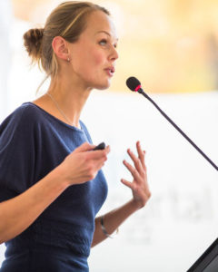 Presenter at podium.