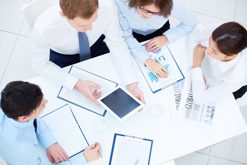 Group of business partners interacting while planning work at meeting